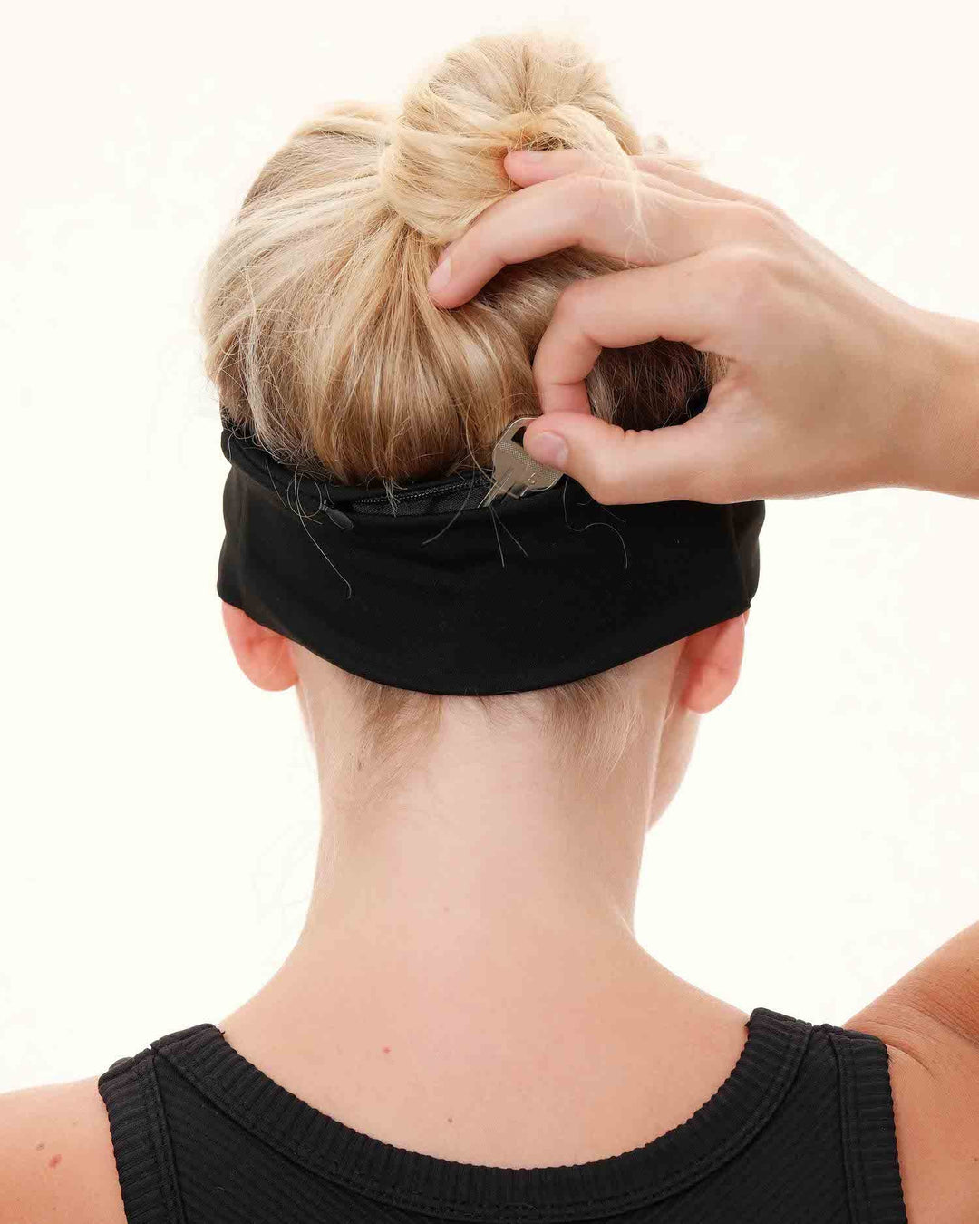 Woman wearing a hidden pocket athletic headband during a workout session.