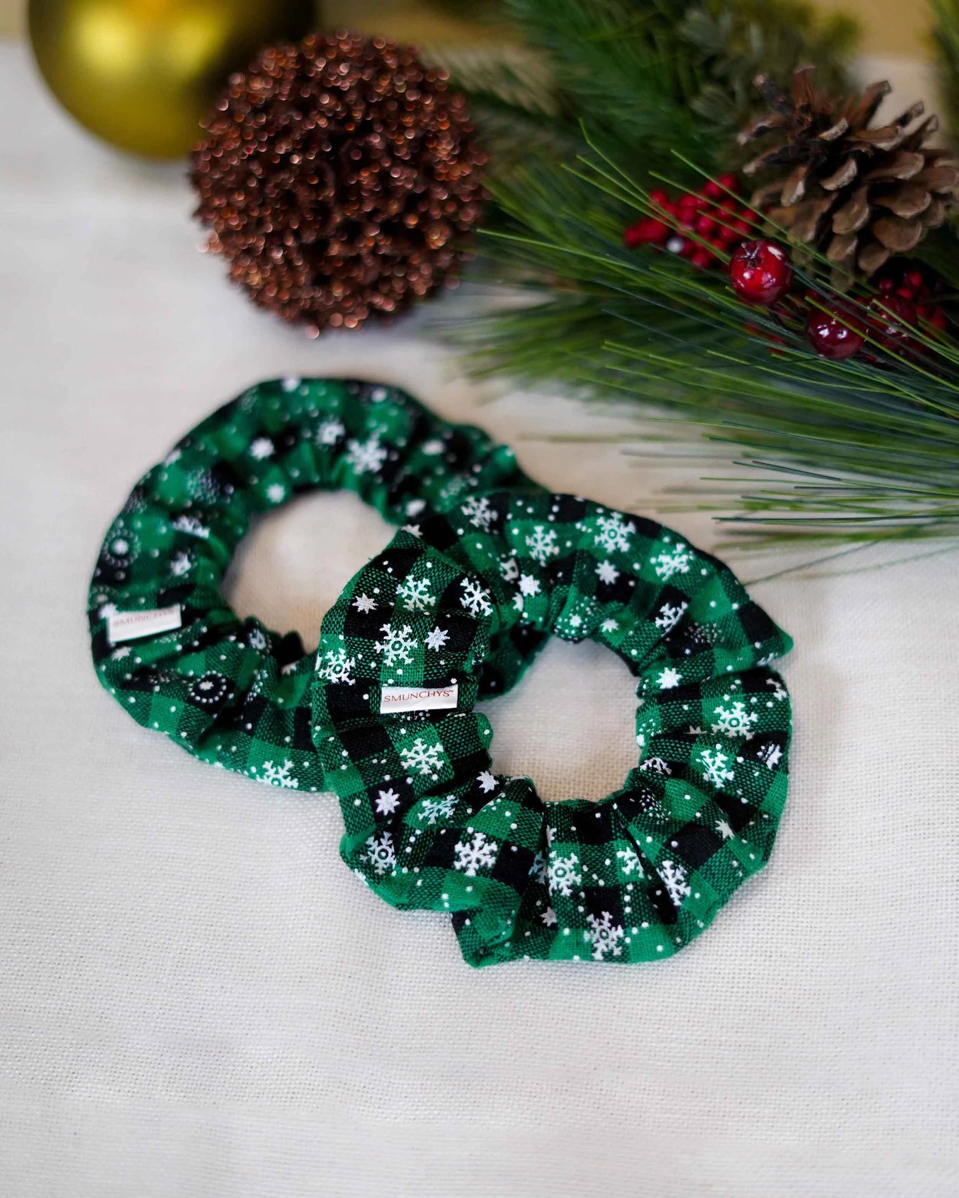 Cotton green holiday scrunchie with snowflakes and hidden zipper pocket for valuables (cash, keys, AirPods), featuring strong elastic for a secure hold. Inspired by the Christmas and winter season, perfect for workouts, festivals, and holiday events.