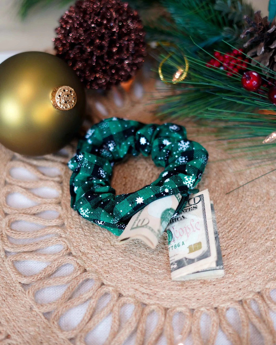 Cotton green holiday scrunchie with snowflakes and hidden zipper pocket for valuables (cash, keys, AirPods), featuring strong elastic for a secure hold. Inspired by the Christmas and winter season, perfect for workouts, festivals, and holiday events.