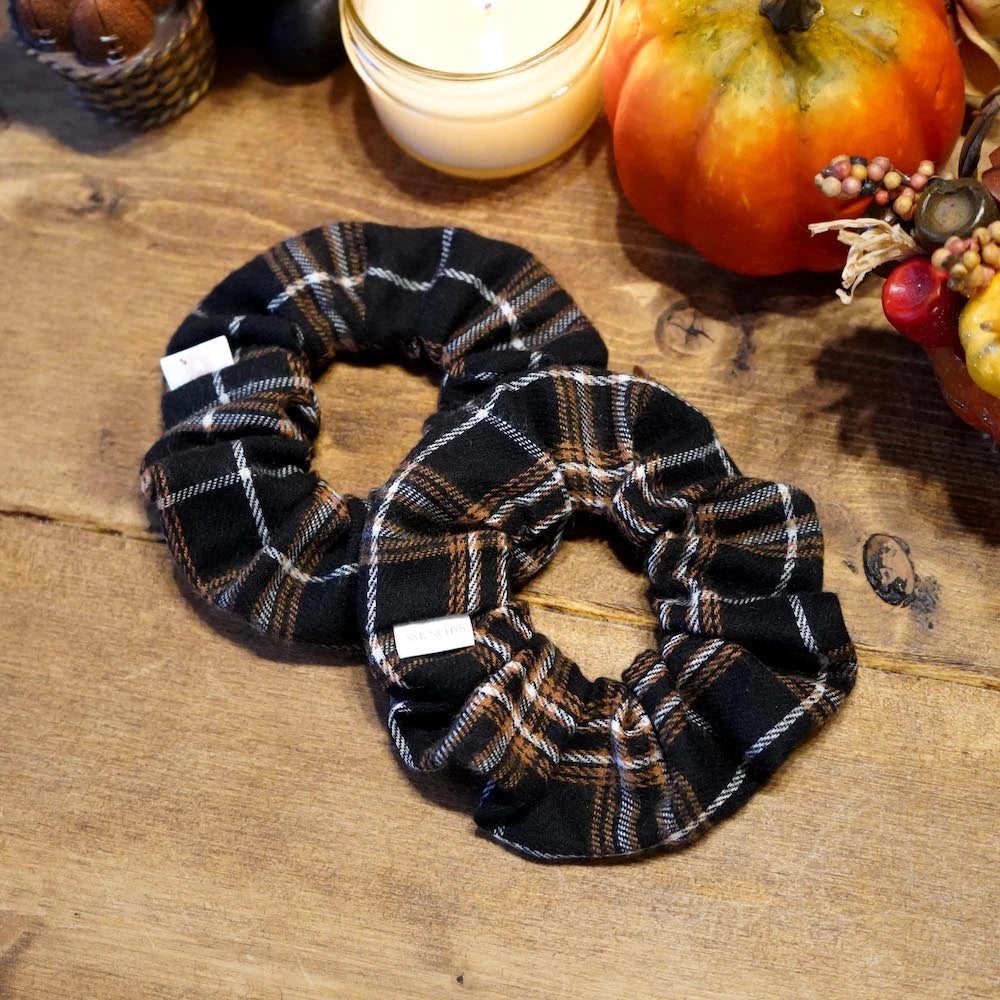 Brown and cream plaid flannel scrunchie with hidden zipper pocket for valuables (cash, keys, AirPods), featuring strong elastic for a secure hold, inspired by Halloween and the fall season, perfect for workouts and festivals.
