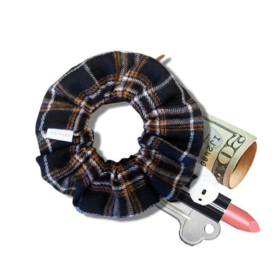 Brown and cream plaid flannel scrunchie with hidden zipper pocket for valuables (cash, keys, AirPods), featuring strong elastic for a secure hold, inspired by Halloween and the fall season, perfect for workouts and festivals.
