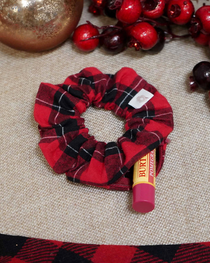 Red flannel holiday scrunchie with a hidden zipper pocket for valuables (cash, keys, AirPods), featuring strong elastic for a secure hold. Inspired by the Christmas season, perfect for workouts, festivals, and holiday events.