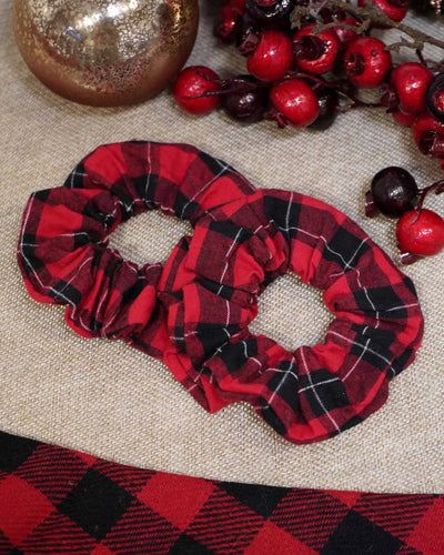 Red flannel holiday scrunchie with a hidden zipper pocket for valuables (cash, keys, AirPods), featuring strong elastic for a secure hold. Inspired by the Christmas season, perfect for workouts, festivals, and holiday events.