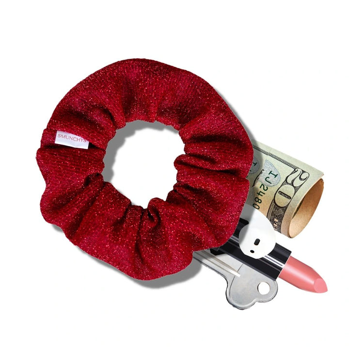 Red sparkly holiday scrunchie with hidden zipper pocket for valuables (cash, keys, AirPods), featuring strong elastic for a secure hold. Inspired by the Christmas season, perfect for workouts, festivals, and holiday events.