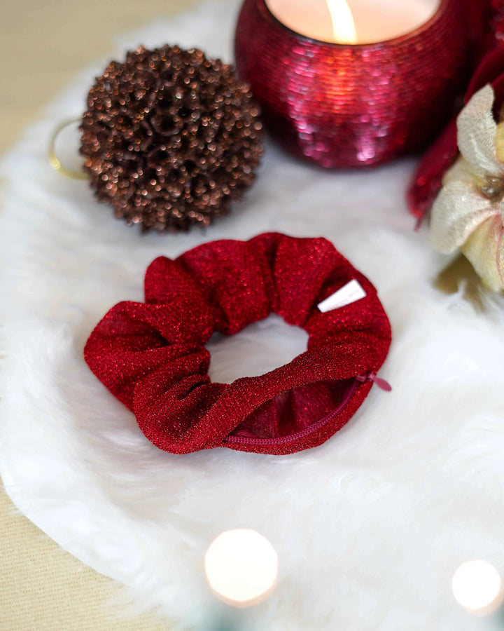 Red sparkly holiday scrunchie with hidden zipper pocket for valuables (cash, keys, AirPods), featuring strong elastic for a secure hold. Inspired by the Christmas season, perfect for workouts, festivals, and holiday events.