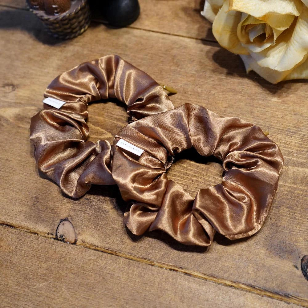 Satin caramel fall scrunchie with a hidden zipper pocket for valuables (cash, keys, AirPods), featuring strong elastic for a secure hold, inspired by the fall season, perfect for workouts and festivals.