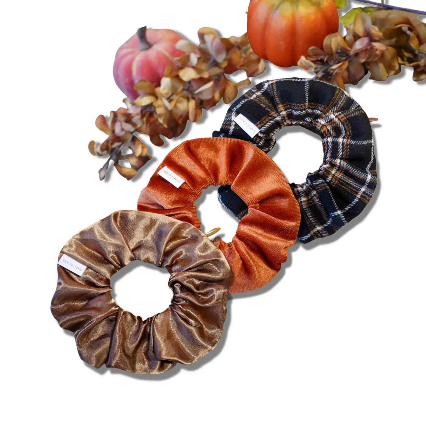 Satin caramel, velvet pumpkin, and fall flannel scrunchies with hidden zipper pockets for valuables (cash, keys, AirPods), featuring strong elastic for a secure hold. Inspired by the fall and Halloween season, perfect for workouts, festivals, and seasonal events.