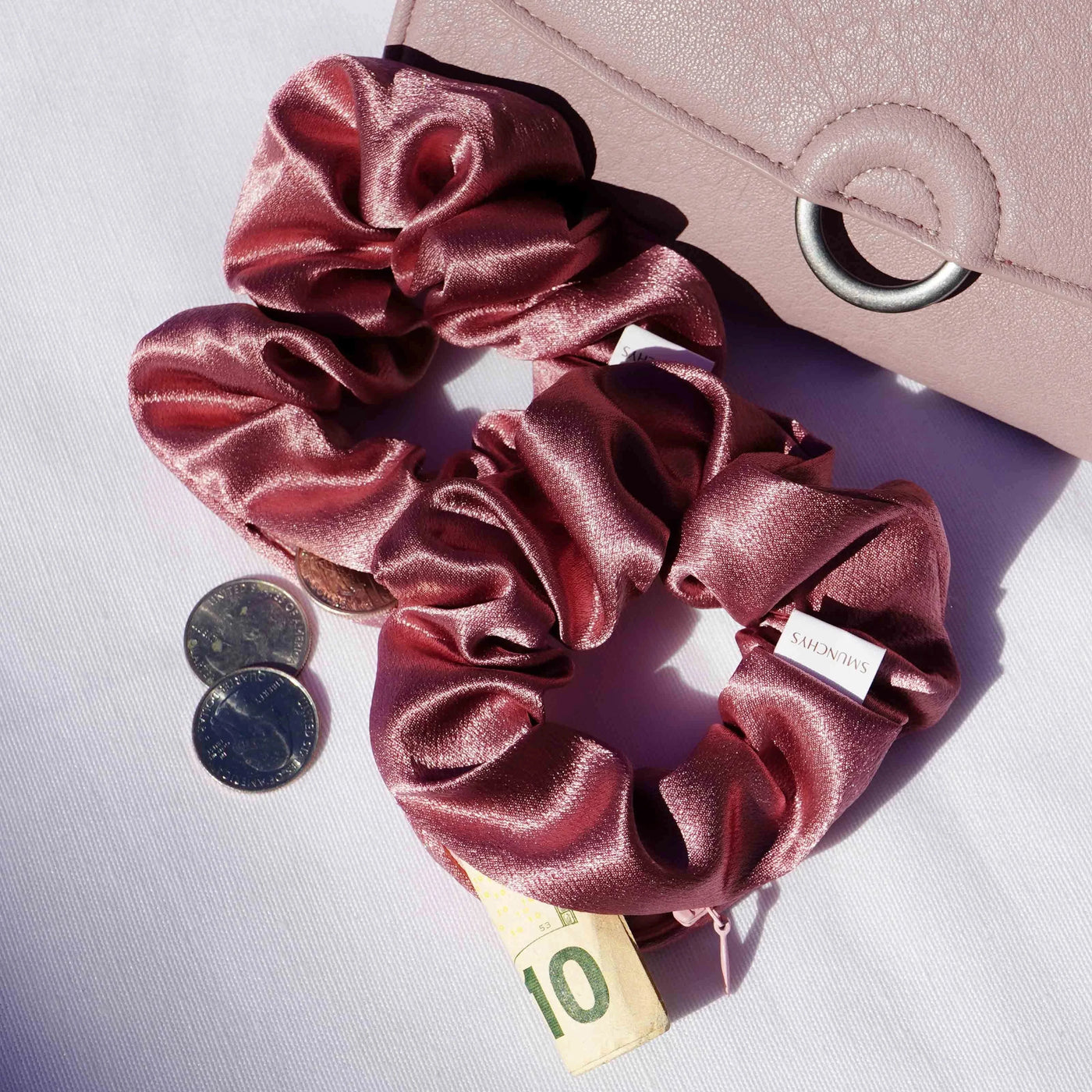 Satin dark pink hair scrunchie ponytail holder featuring a hidden zipper pocket for storing valuables (cash, keys, AirPods) and strong elastic for a secure hold. Perfect for workouts, festivals, gifts, and holiday stocking stuffers.