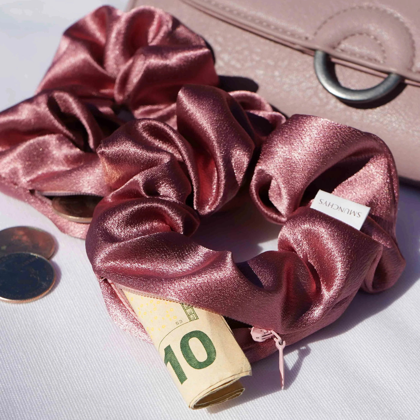 Satin dark pink hair scrunchie ponytail holder featuring a hidden zipper pocket for storing valuables (cash, keys, AirPods) and strong elastic for a secure hold. Perfect for workouts, festivals, gifts, and holiday stocking stuffers.