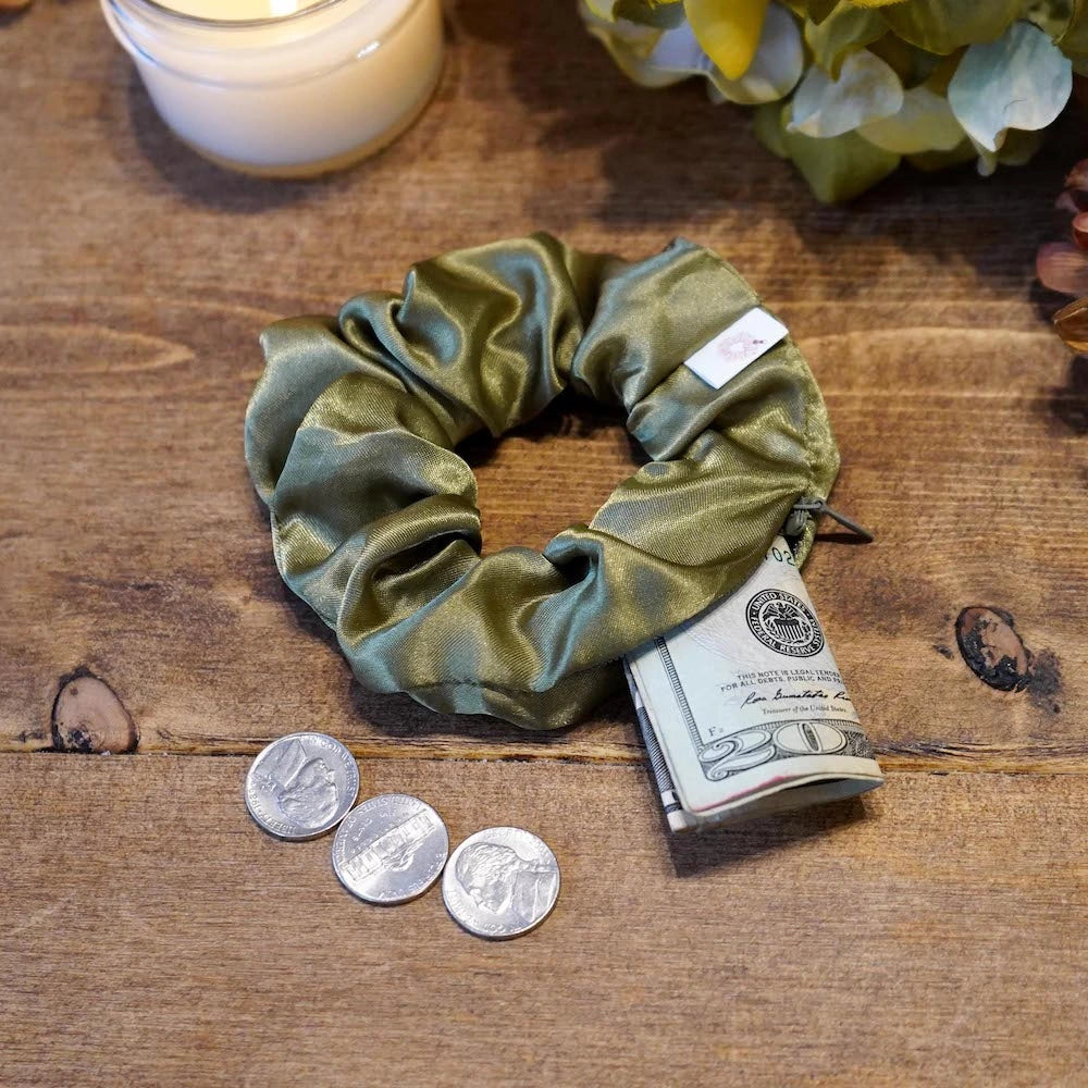 Satin green fall scrunchie with a hidden zipper pocket for valuables (cash, keys, AirPods), featuring strong elastic for a secure hold, inspired by the fall season, perfect for workouts and festivals.