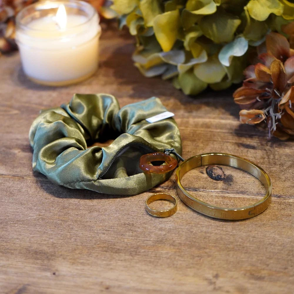 Satin green fall scrunchie with a hidden zipper pocket for valuables (cash, keys, AirPods), featuring strong elastic for a secure hold, inspired by the fall season, perfect for workouts and festivals.