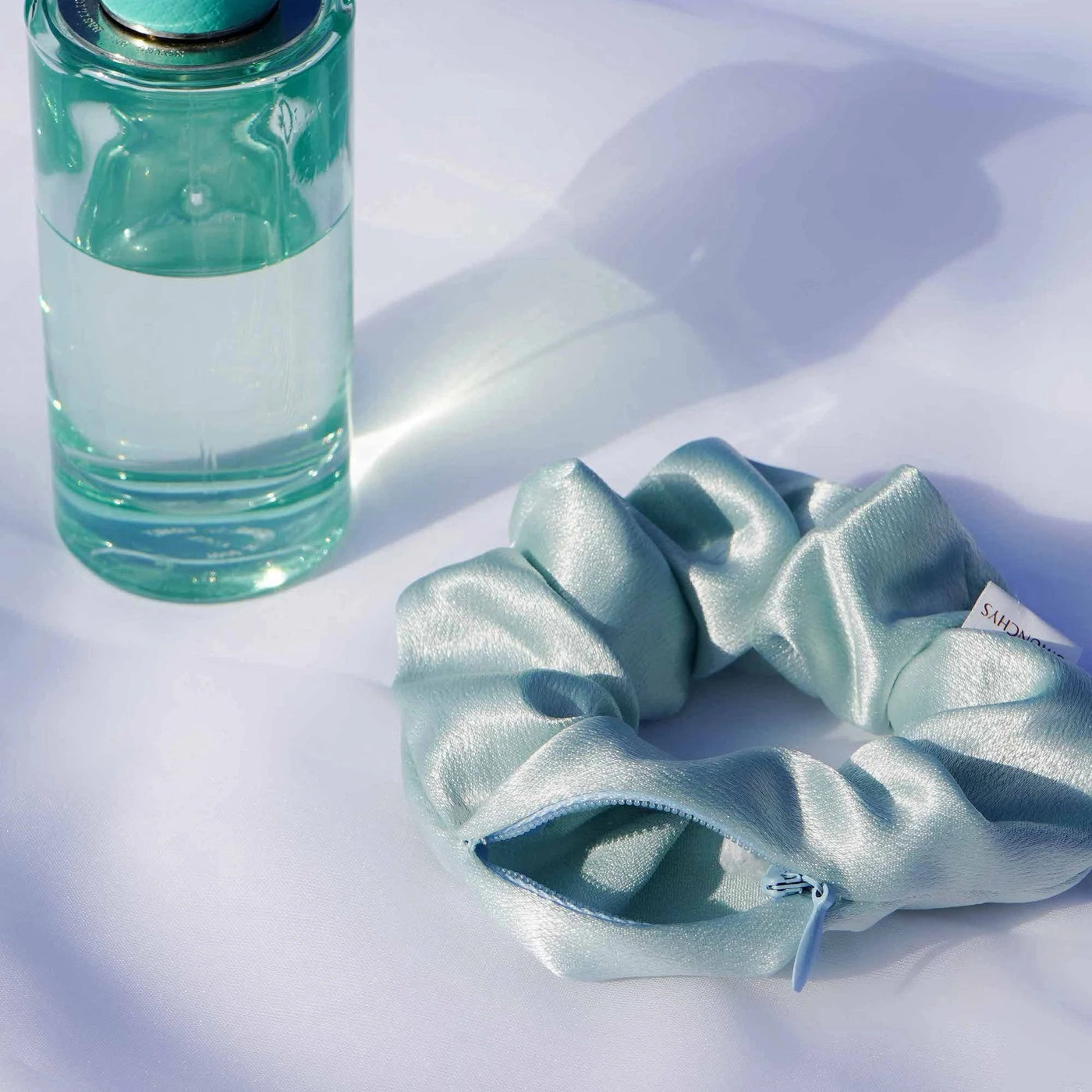 Satin light green and light blue Tiffany blue color hair scrunchie ponytail holder featuring a hidden zipper pocket for storing valuables (cash, keys, AirPods) and strong elastic for a secure hold. Ideal for workouts, festivals, gifts, and holiday stocking stuffers.