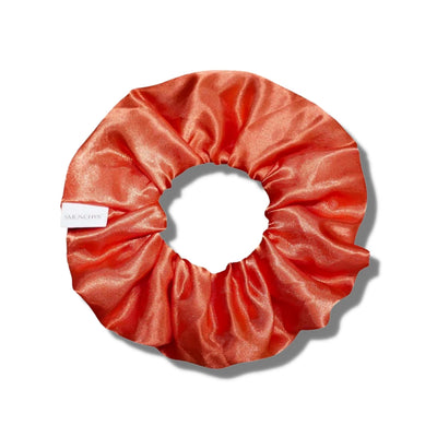 Satin orange fall scrunchie with a hidden zipper pocket for valuables (cash, keys, AirPods), featuring strong elastic for a secure hold, inspired by Halloween, perfect for workouts and festivals.