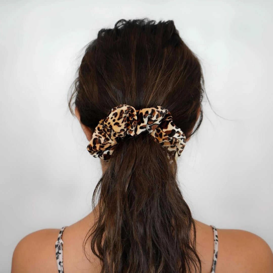 Velvet cream and beige leopard print hair scrunchie ponytail holder featuring a hidden zipper pocket for storing valuables (cash, keys, AirPods) and strong elastic for a secure hold. Ideal for workouts, festivals, gifts, and holiday stocking stuffers.